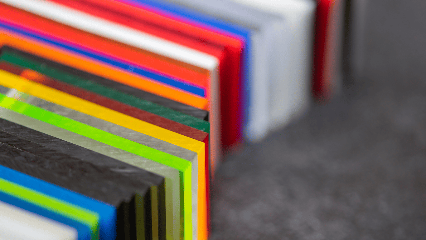 Worker inspecting acrylic display boxes for clarity and defects